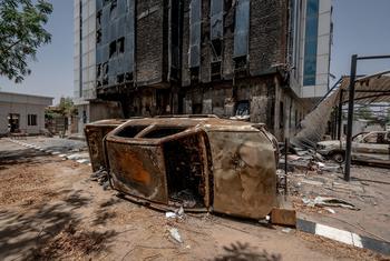 An upturned vehicle lies in front of a building in the Sudanese capital, Khartoum. (file) 