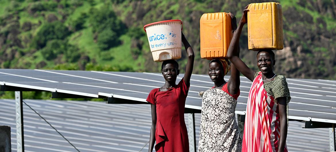 Girls walking home after fetching water, in Itang Woreda, in the Gambela region of Ethiopia..