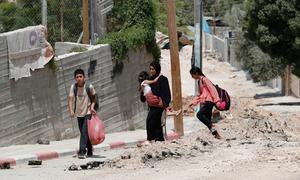 Members of a family flee Jenin due to an escalation of violence.