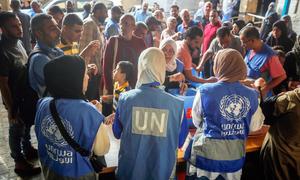 UNRWA staff with displaced people in Gaza.