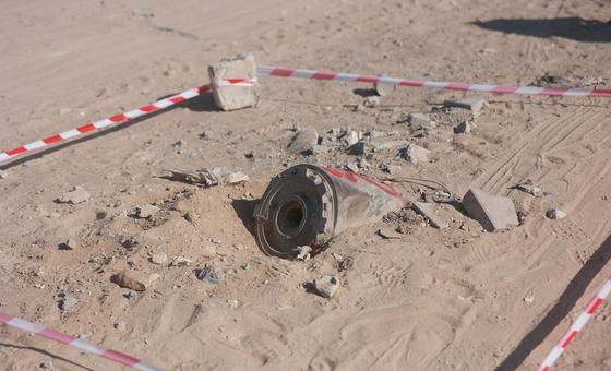 The remnant of a shell lies buried in the sand in Gaza.