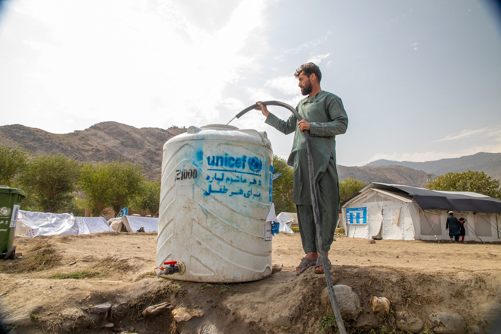 A man fills a tank with fresh water at the Zor Kali Camp in Kunar province, Afghanistan.