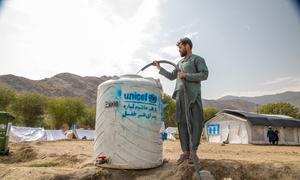 A man fills a tank with fresh water at the Zor Kali Camp in Kunar province, Afghanistan.