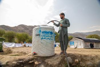 A man fills a tank with fresh water at the Zor Kali Camp in Kunar province, Afghanistan.