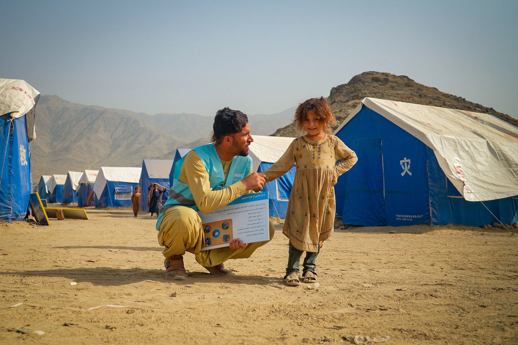 Гуманитарный сотрудник с девочкой, живущей в лагере для перемещенных лиц в Афганистане, недалеко от границы с Пакистаном.