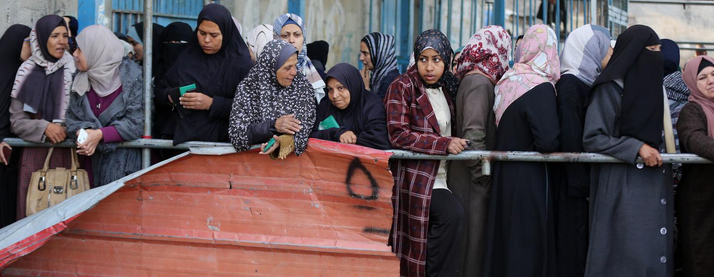 Women in Gaza queue at a food distribution point.