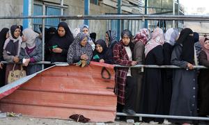 Women in Gaza queue at a food distribution point.