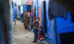 A child cleans a temporary shelter in Gaza.
