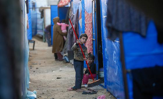 A child cleans a temporary shelter in Gaza.
