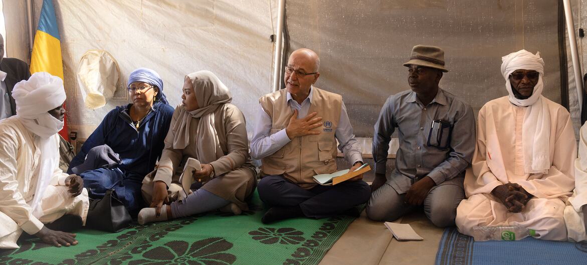 Barham Salih, UN High Commissioner for Refugees, speaks with Sudanese refugees at a women's center in Farchana, Chad, listening to their stories of displacement.