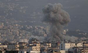 Smoke rises from a building hit by bombing on March 12, 2026, in the Dahieh neighborhood of Beirut, Lebanon.