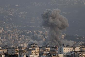 Smoke rises from a building hit by bombing on March 12, 2026, in the Dahieh neighborhood of Beirut, Lebanon.