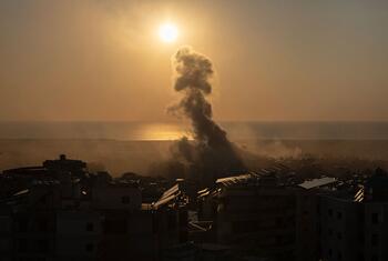 Smoke rises from a building hit by bombing in Beirut, Lebanon, on March 10, 2026, against a sunset backdrop.