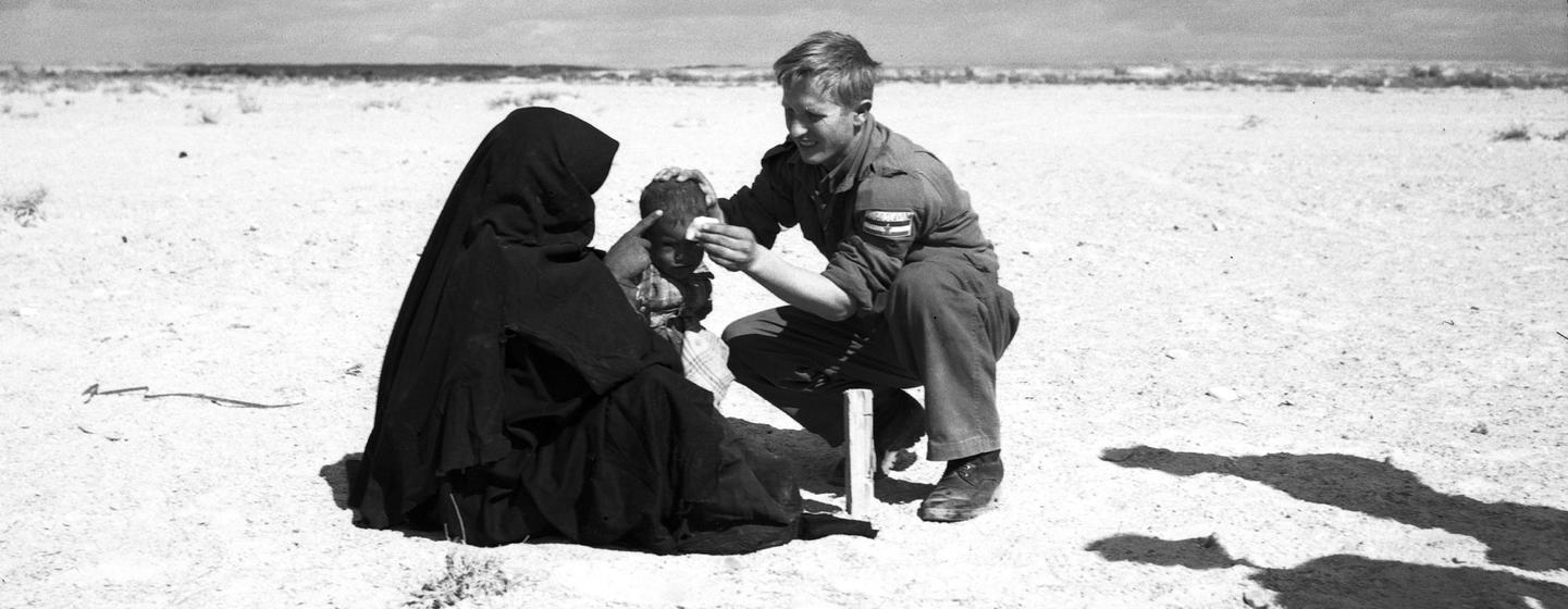 Jelaskovic Ibrahim of the then-Yugoslav medical staff of the UN Emergency Force (UNEF) treats a child in El Kuntilla in the Sinai in Egypt in 1959. (file)
