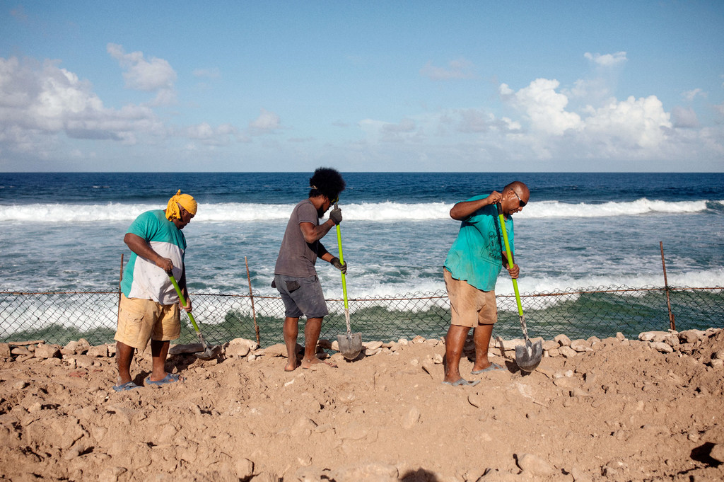 Workers construct barriers to combat sea erosion along the coastline of Tuvalu.