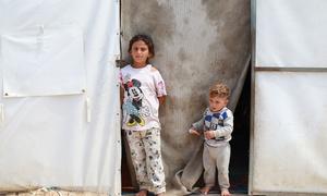 Two children wait at a temporary health centre in Gaza.