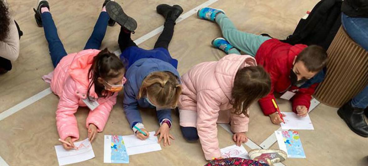 Children participated in drawing activities during an oceanfront event in Venice, Italy.
