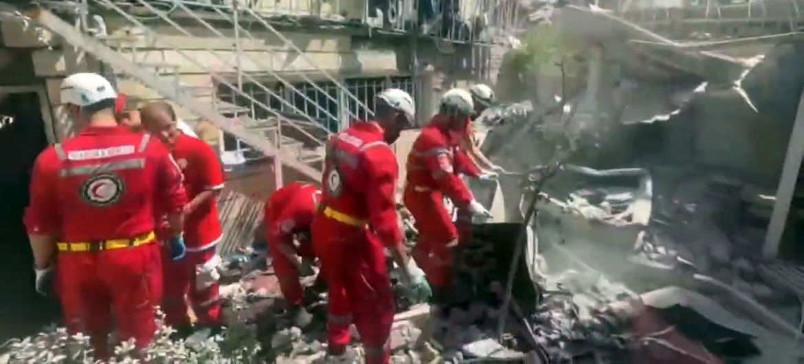 Iranian Red Crescent teams search for survivors after Israeli airstrike.