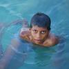 A boy swims in the ocean in the Maldives. Nearly the entire island nation lies less than one meter above sea level, making it highly vulnerable to the impacts of climate change.