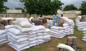 WFP prepares food for distribution in Forbaranga, West Darfur.