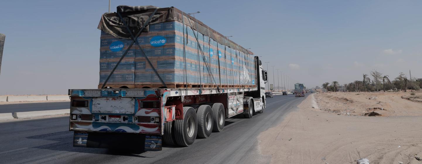 Trucks loaded with bottles of drinking water travel near El Arish, Egypt.