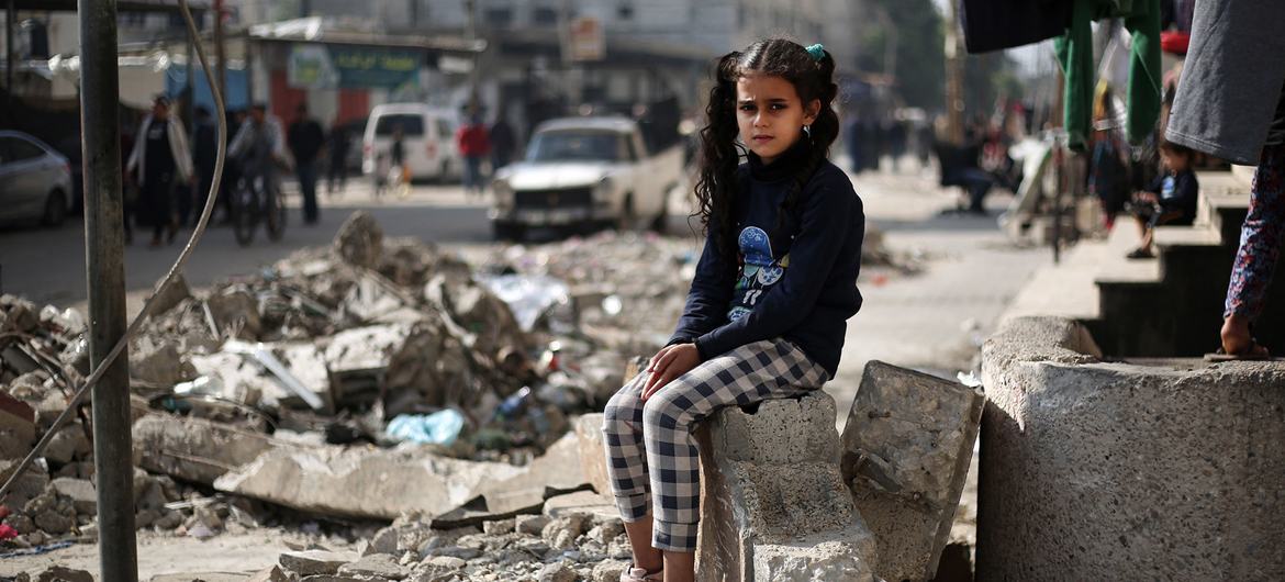 An 11-year-old girl sits on the rubble of a house in Rafah, in the southern the Gaza Strip.