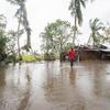 A man walks through his village in Nicoadala district, Mozambique, which was flooded as a result of cyclone Freddy.