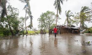 A man walks through his village in Nicoadala district, Mozambique, which was flooded as a result of cyclone Freddy.