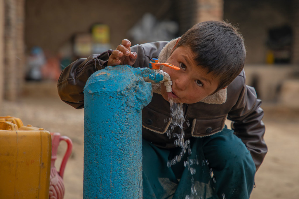 A boy uses a water tap, newly installed by the UN in Faryab province, Afghanistan.