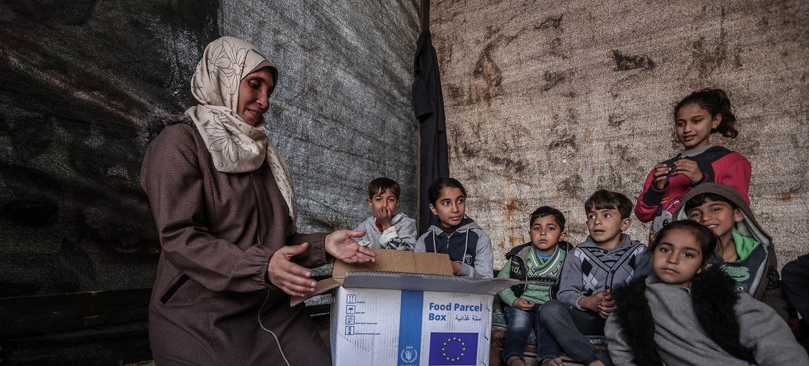 A family in Gaza receives a box of food. (file)