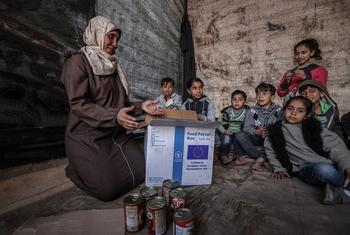 A family in Gaza receives a box of food. (file)
