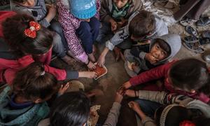 Children share a small amount of food provided by the UN's World Food Programme.