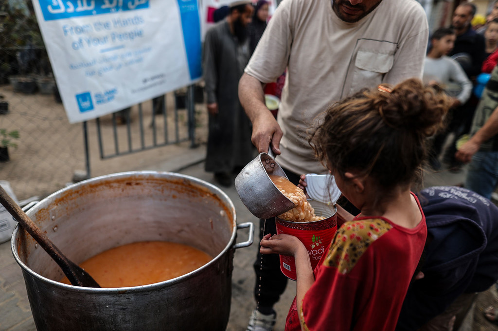 A young girl receives food from an outside kitchen supported by the World Food Progamme (WFP) (file).