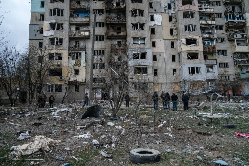 Residents assess the damage to buildings in Kupiansk, in the Kharkiv region of Ukraine. (file photo)