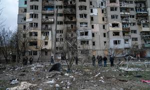 Residents assess the damage to buildings in Kupiansk, in the Kharkiv region of Ukraine. (file photo)