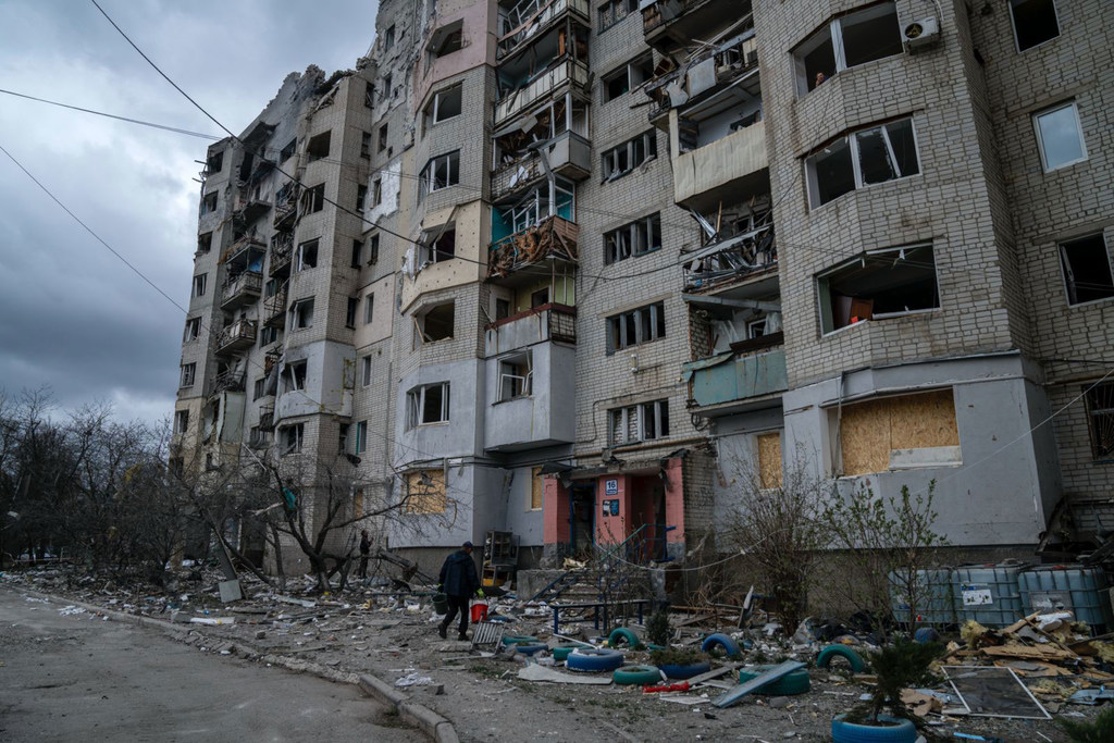 A person walks into a destroyed building in Kupiansk in eastern Ukraine.