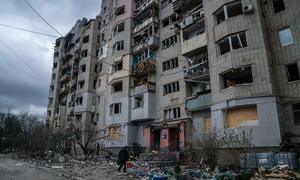 A person walks into a destroyed building in Kupiansk in eastern Ukraine.