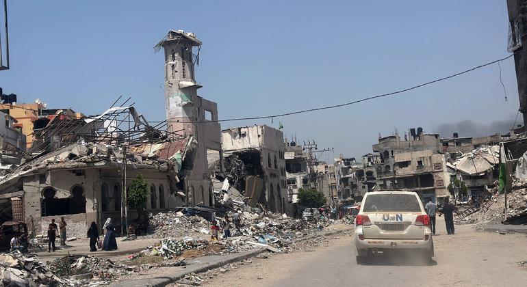 A UN vehicle passes through the ruins of Gaza City.