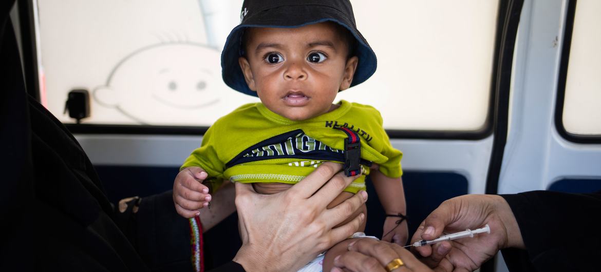 A 6-month-old boy is immunized at a mobile vaccination unit in Sindh province, Pakistan.