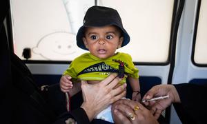 A 6-month-old boy is immunized at a mobile vaccination unit in Sindh province, Pakistan.