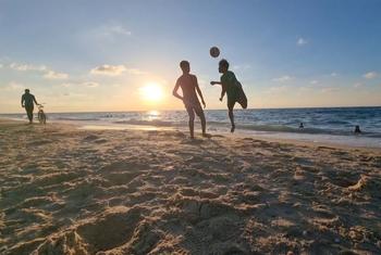 Two football players practice on a beach in Gaza.