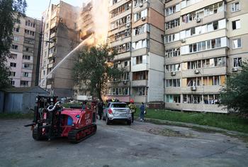Rescue workers extinguish a fire in a residential building in the Ukrainian capital, Kyiv.
