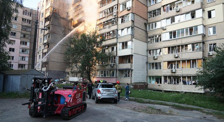 Rescue workers extinguish a fire in a residential building in the Ukrainian capital, Kyiv.