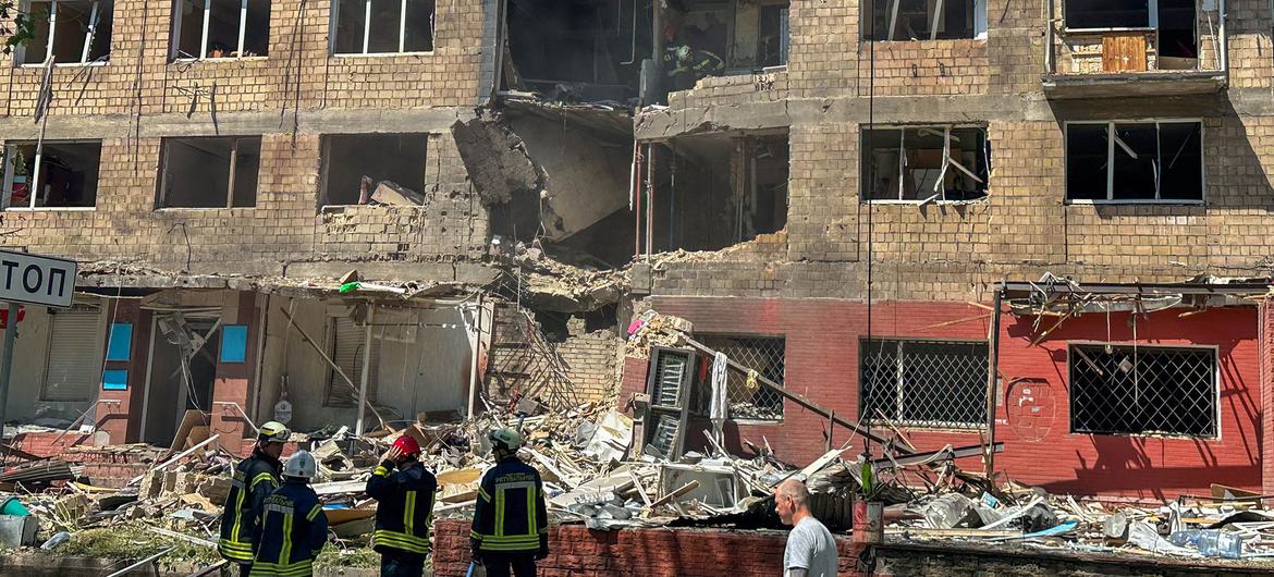 Rescue workers stand outside a bombed building in Kyiv, Ukraine's capital. Rescue workers stand outside a bombed building in Kyiv, Ukraine's capital.