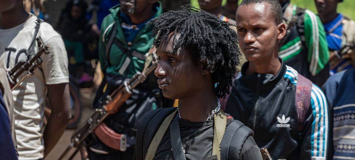 A young member of an armed group in the Central African Republic prepares to hand in his weapon. A young member of an armed group in the Central African Republic prepares to hand in his weapon.