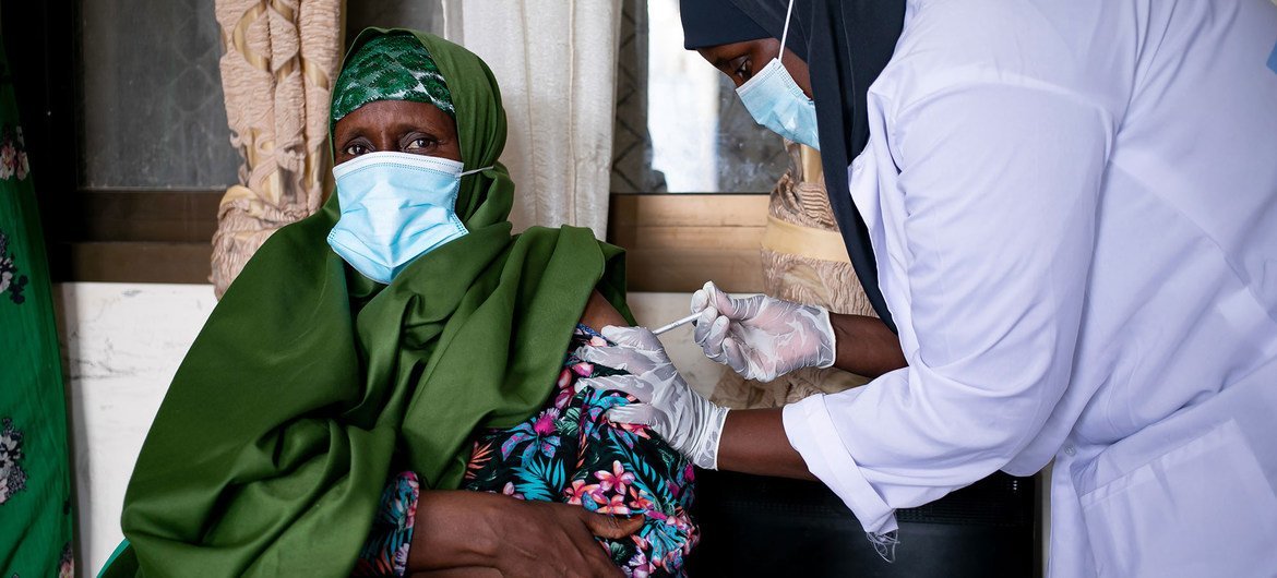 A woman receives a dose of a COVID-19 vaccine at a health clinic in Garowe, Somalia.