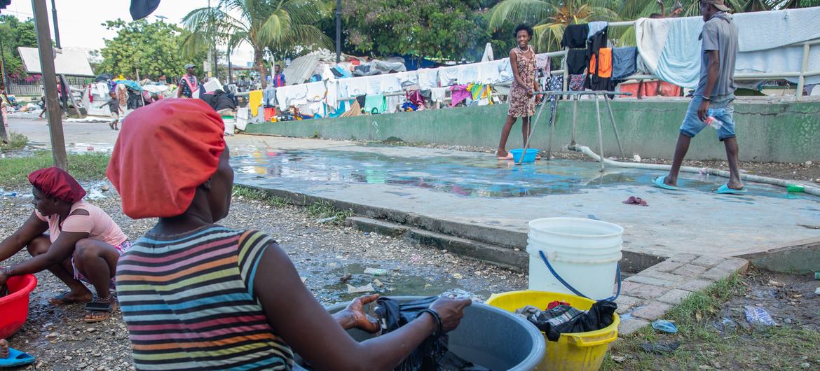 A woman displaced by violence in the Haitian capital, Port-au-Prince, washes clothes in a city park.