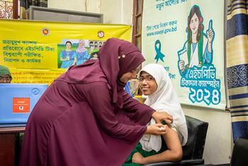 A girl in Mymensingh, Bangladesh, receives an HPV vaccine which can help to prevent cervical cancer.
