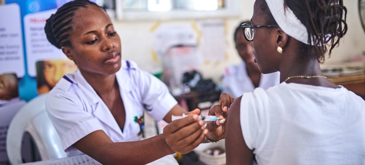 A health worker immunizes a girl with the HPV vaccine in Lagos, Nigeria, as part of Africa’s largest vaccination campaign.