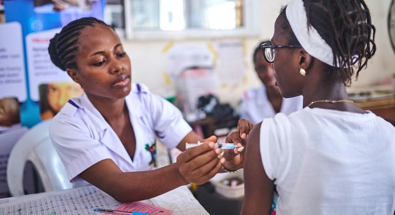 A health worker immunizes a girl with the HPV vaccine in Lagos, Nigeria, as part of Africa’s largest vaccination campaign.